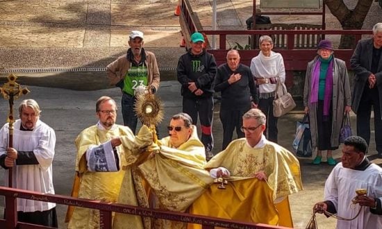 Priests and parishioners outside during a Corpus Christi procession
