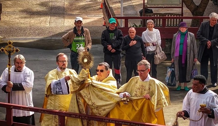 Priests and parishioners outside during a Corpus Christi procession
