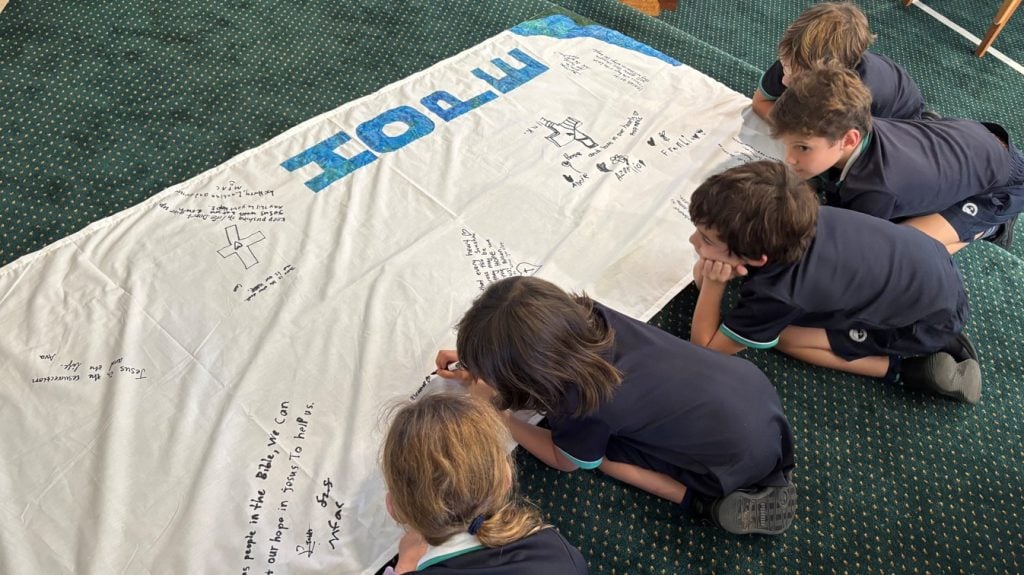 Students signing a banner