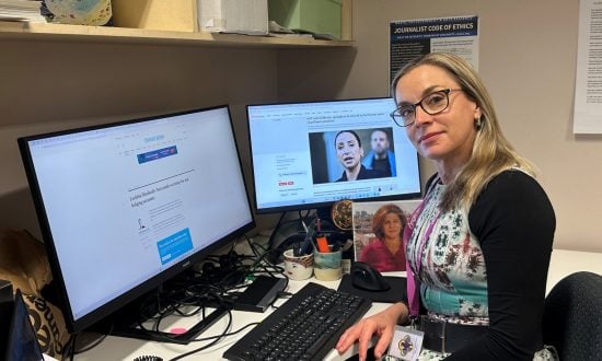 Woman journalist at desk in work office