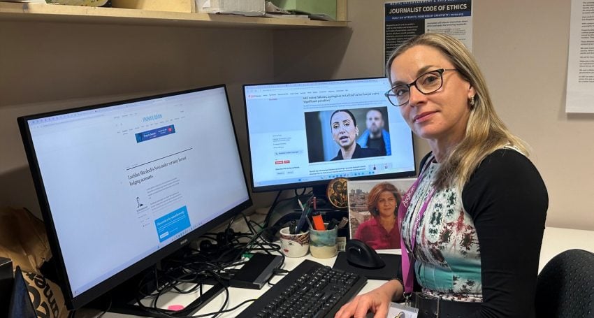 Woman journalist at desk in work office