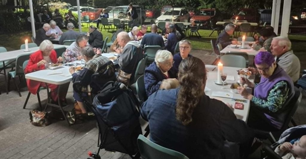 People eating at tables outside 