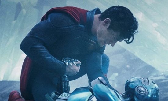 Superman leans over a robot
