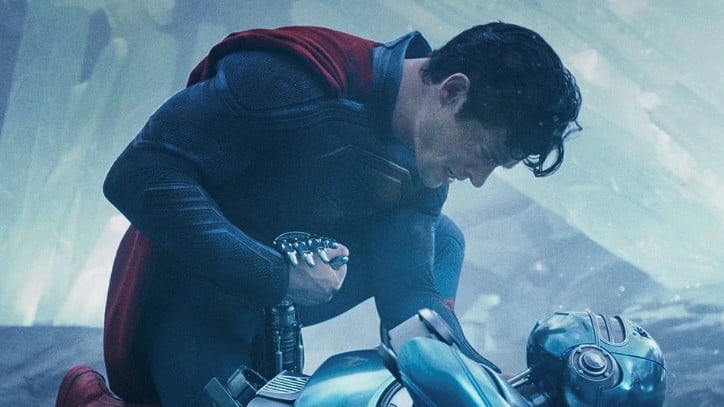 Superman leans over a robot