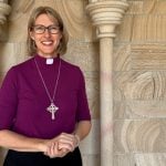 Woman bishop outside a cathedral