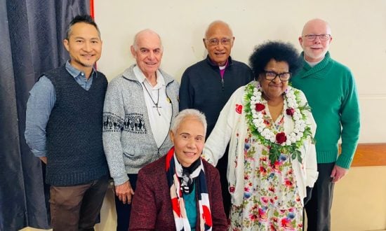Six diverse people at a conference smiling