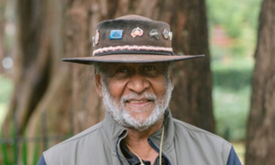Aboriginal Elder in a hat smiling at the camera