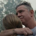 A father embraces his daughter