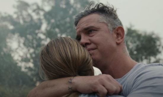 A father embraces his daughter