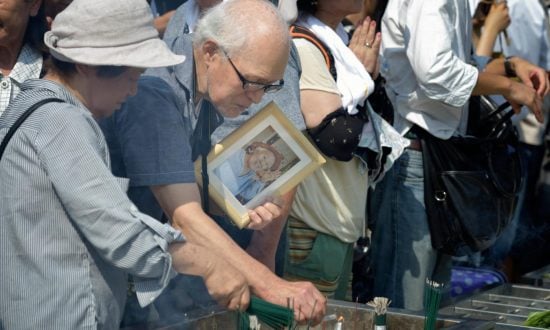 A group of people attend a memorial for victims of the atomic bombing at Hiroshima